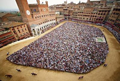 Piazza del Campo during the Palio, packed with spectators.