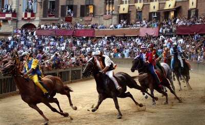 Horses racing around Piazza del Campo (Palio di Siena)